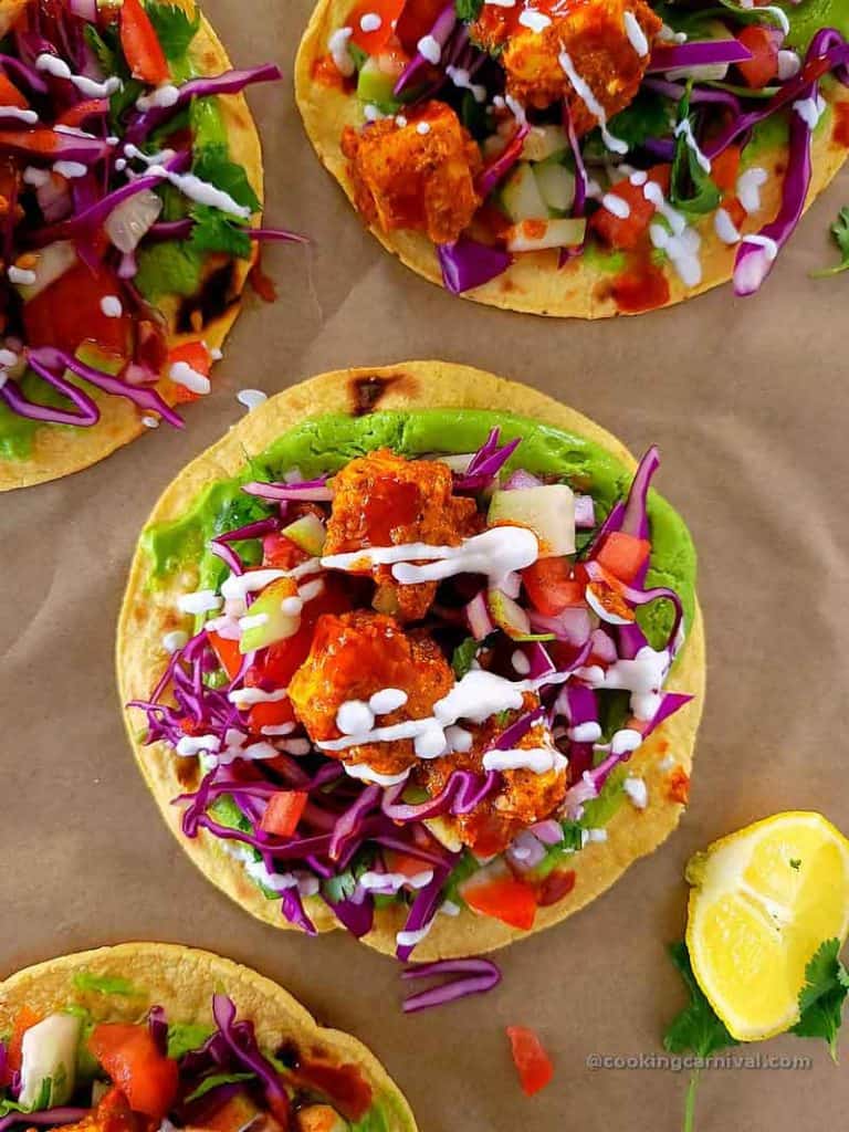 Achari paneer taco on a paper