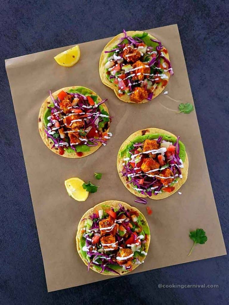 4 Achari paneer tacos on a tile