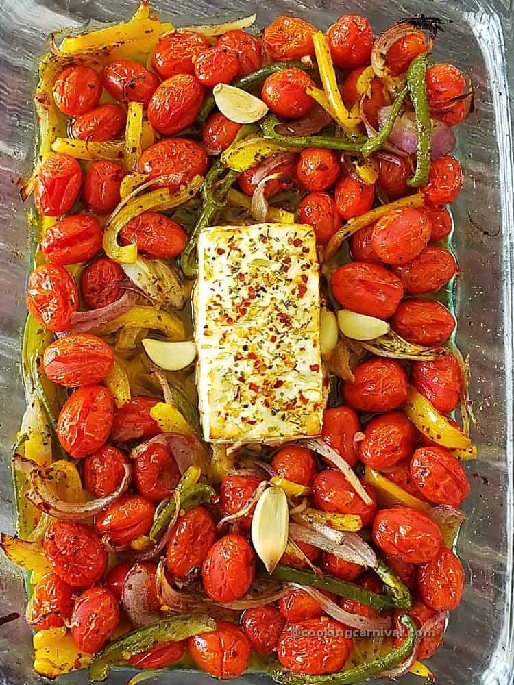 baked feta cheese, tomato and vegetable in baking dish