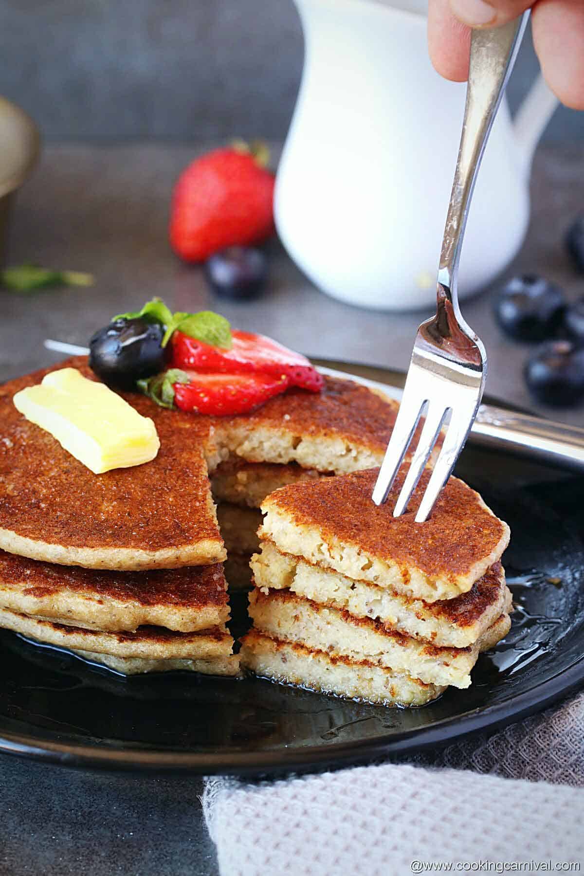 Taking pancake bite with fork