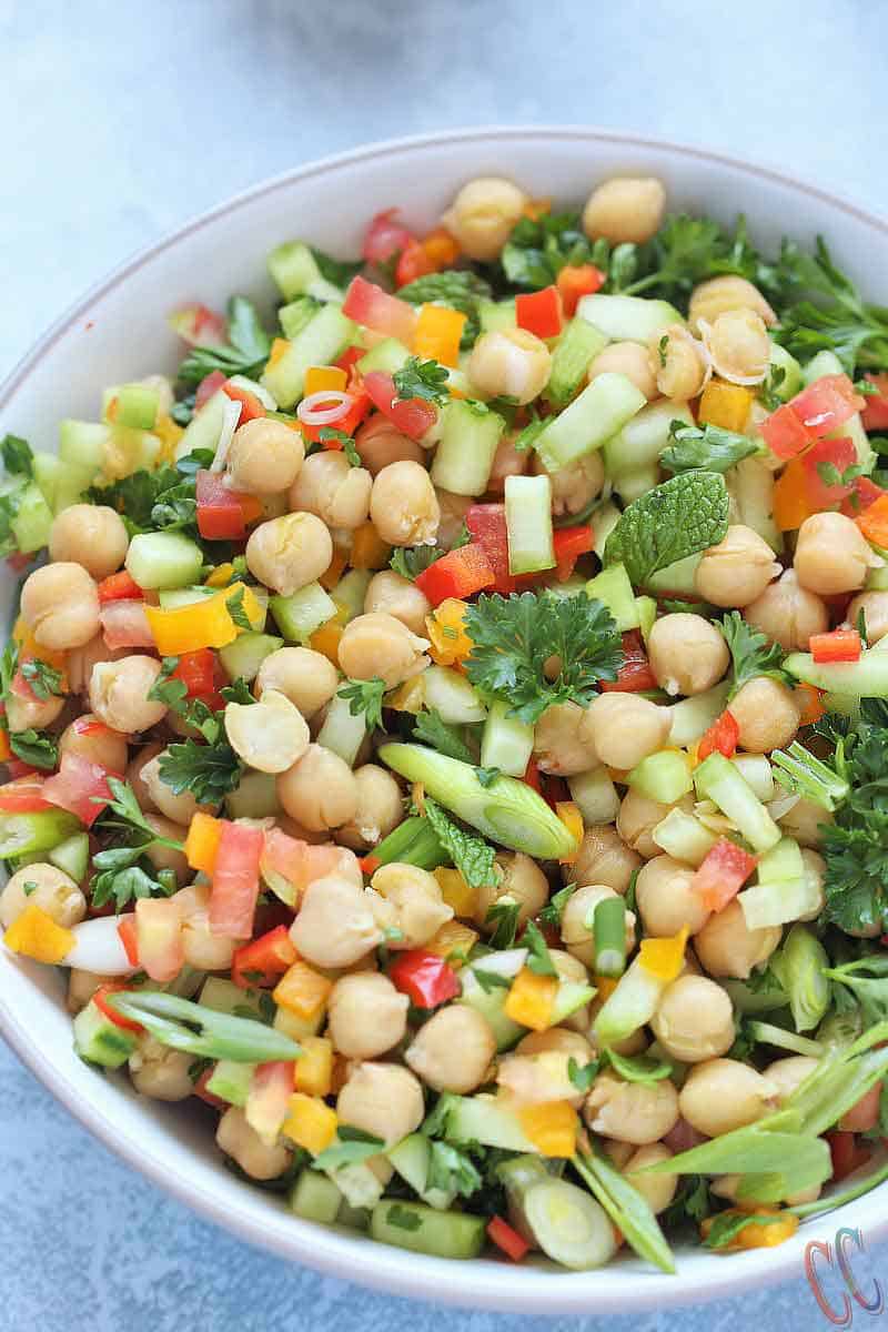 Balela Salad (Bah-lay-la salad) is Middle Eastern-style Chickpea salad. This hearty refreshing salad is bursting with zesty flavor. So easy, so delicious, nutrient dense and satisfying meal! It is perfect for any party or busy weeknight meal.