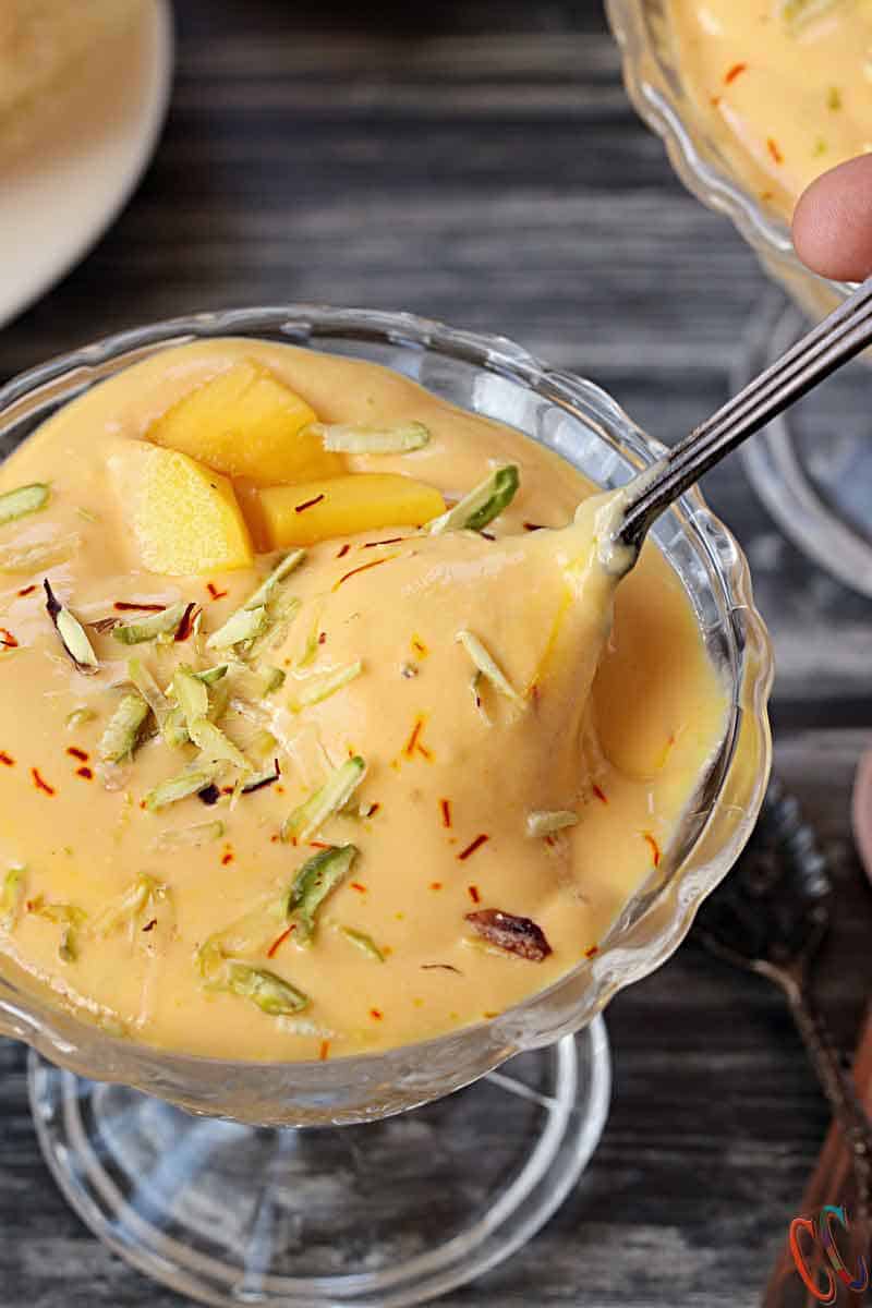 Mango Shrikhand | Aamrkhand - Lush Mango flavored Popular Indian Dessert made with Greek or Thick yogurt, Mango, sweetener, Cardamom, some pistachios and aromatic Saffron.