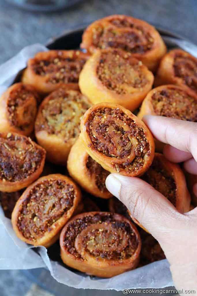 taking gujarati snack bhakarwadi from the pan