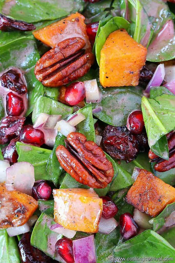 Close up look of Butternut squash spinach salad with pomegranate vinaigrette