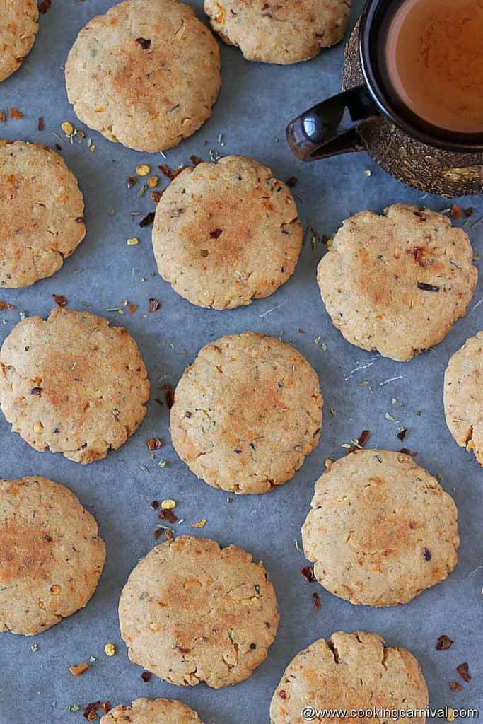 savory cookies on a black tile, chai on the sides