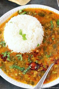 Dal palak on white plate with steamed rice