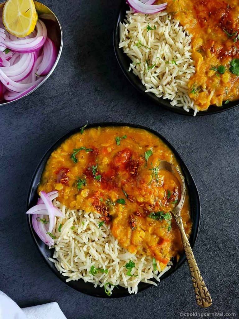 Dal and rice in a black plate