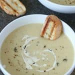 Instant Pot Potato leek Soup in a white bowl with bread