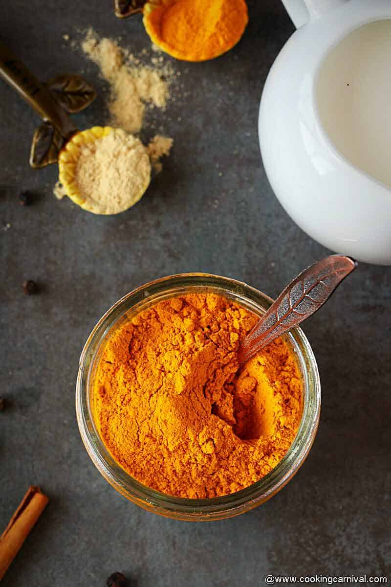 Golden milk spice mix in a mason jar with spoon