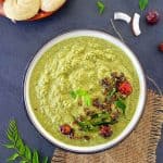 Green coconut chutney in a bowl, idli on the side