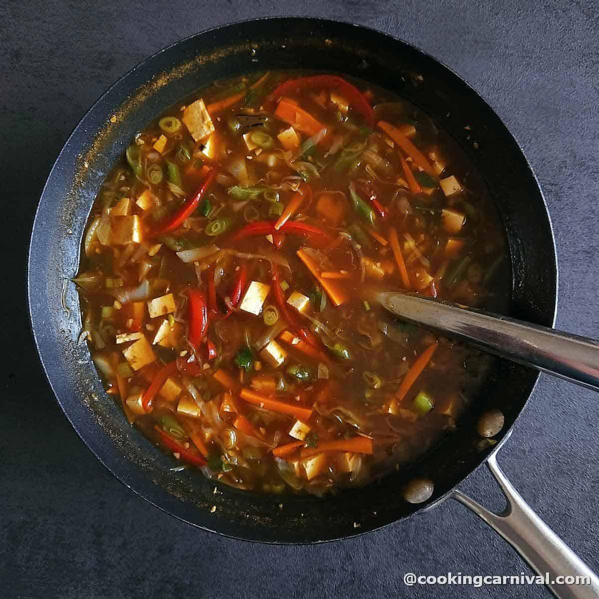 veg hot and sour soup in a wok.