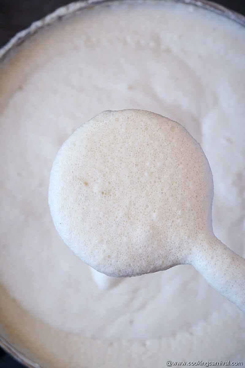 Ladle full of fermented idli batter