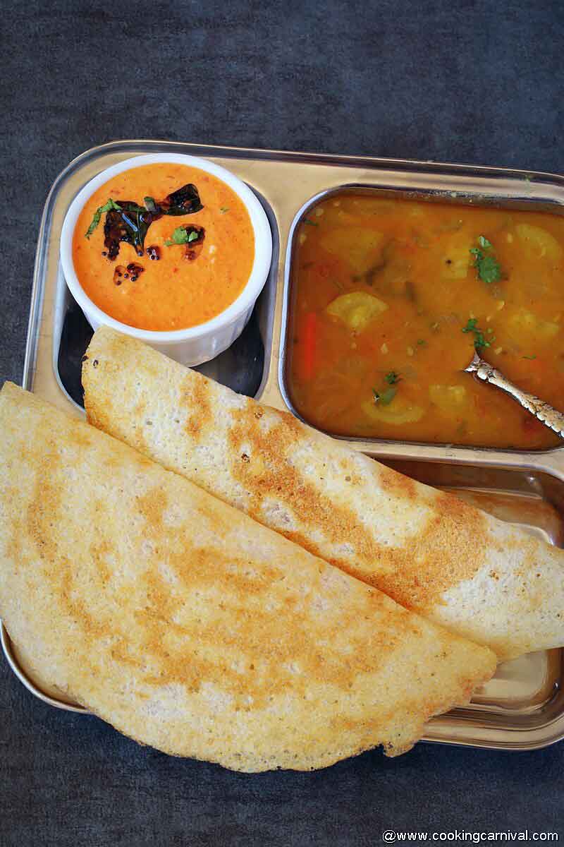 Crispy dosa, sambar and onion chutney in a steel plate