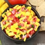 fruity salsa with chips, mango, cilantro on the side