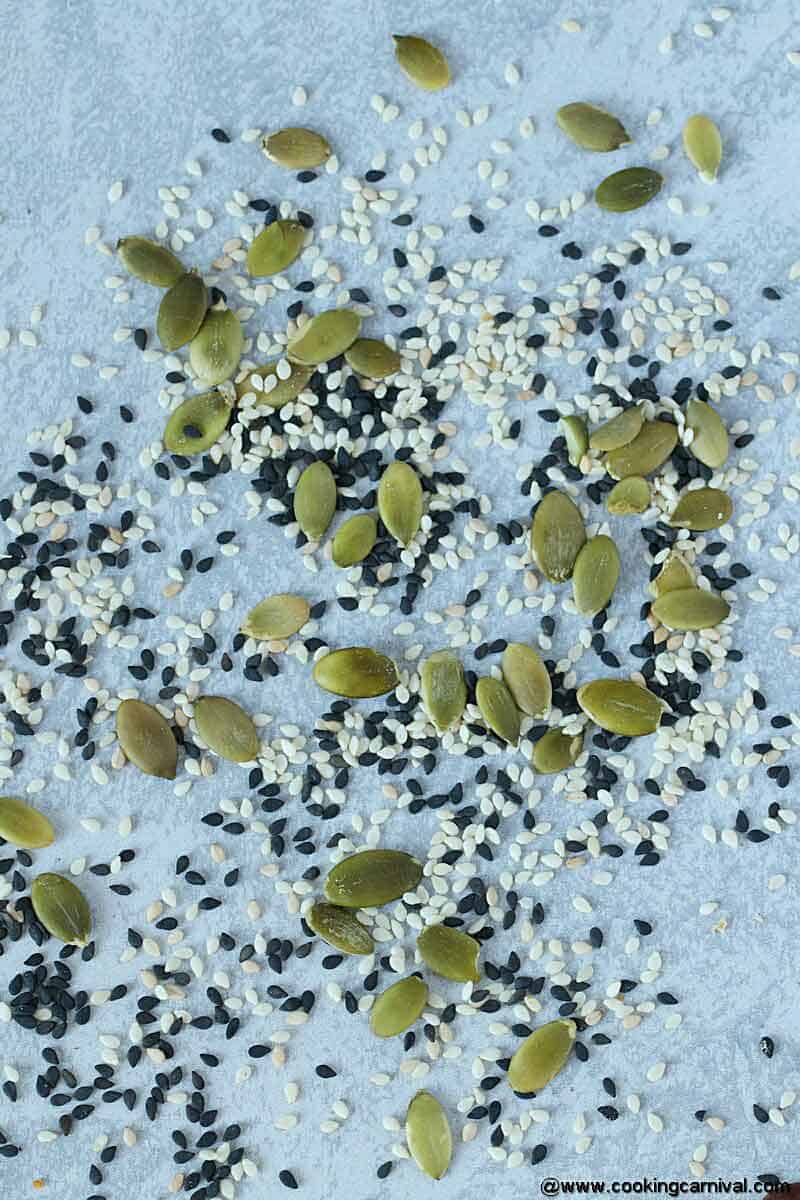 Sesame seeds (White and black) and Pumpkin seeds for pumpkin bread on a gray backdrop