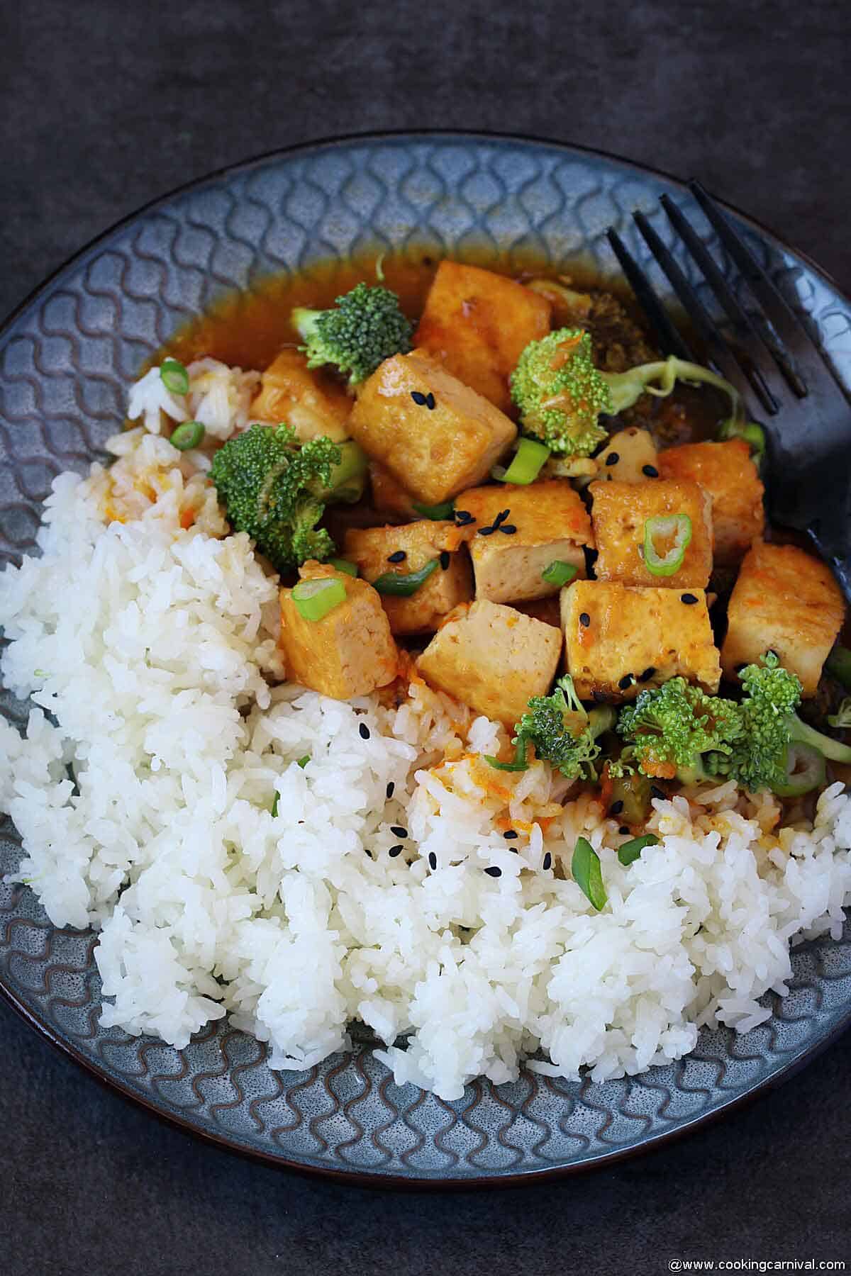 Jasmine rice with orange tofu broccoli in plate