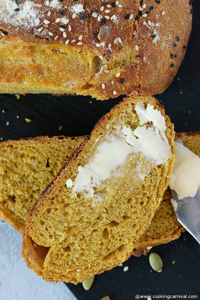 Buttered slice of No knead pumpkin bread