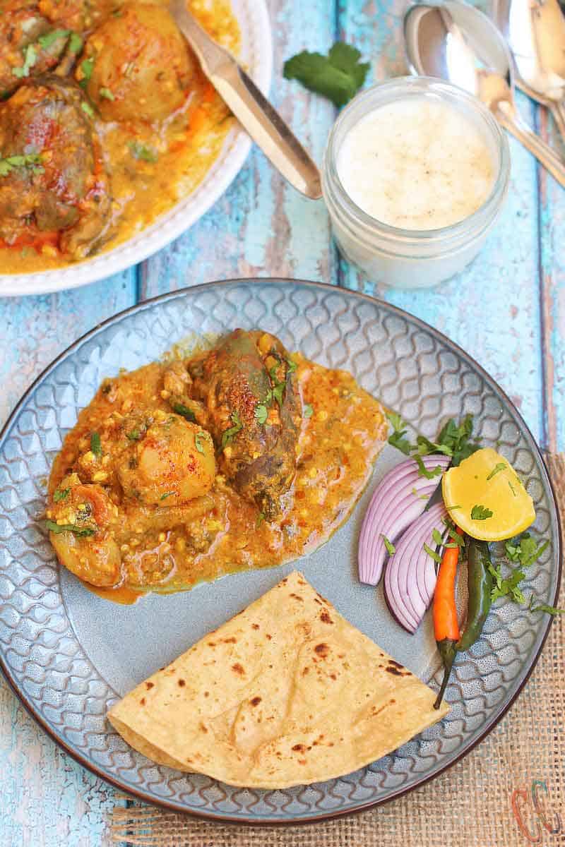 Instant Pot Stuffed Eggplant Potato Curry / Stuffed Aloo Baingun In Pressure Cooker - Simple Flavorful curry that is made in one pot - Instant Pot / Pressure cooker. Pair it with Rice, Roti, naan, Bajri rotla or any Indian Flatbread and you have a complete delicious meal ready on the table under 30 minutes. This recipe is Vegan And Gluten-free. Ringana Batata Nu Bharelu Shak and rotli