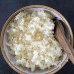 Instant pot sushi rice in a wooden bowl with wooden spatula