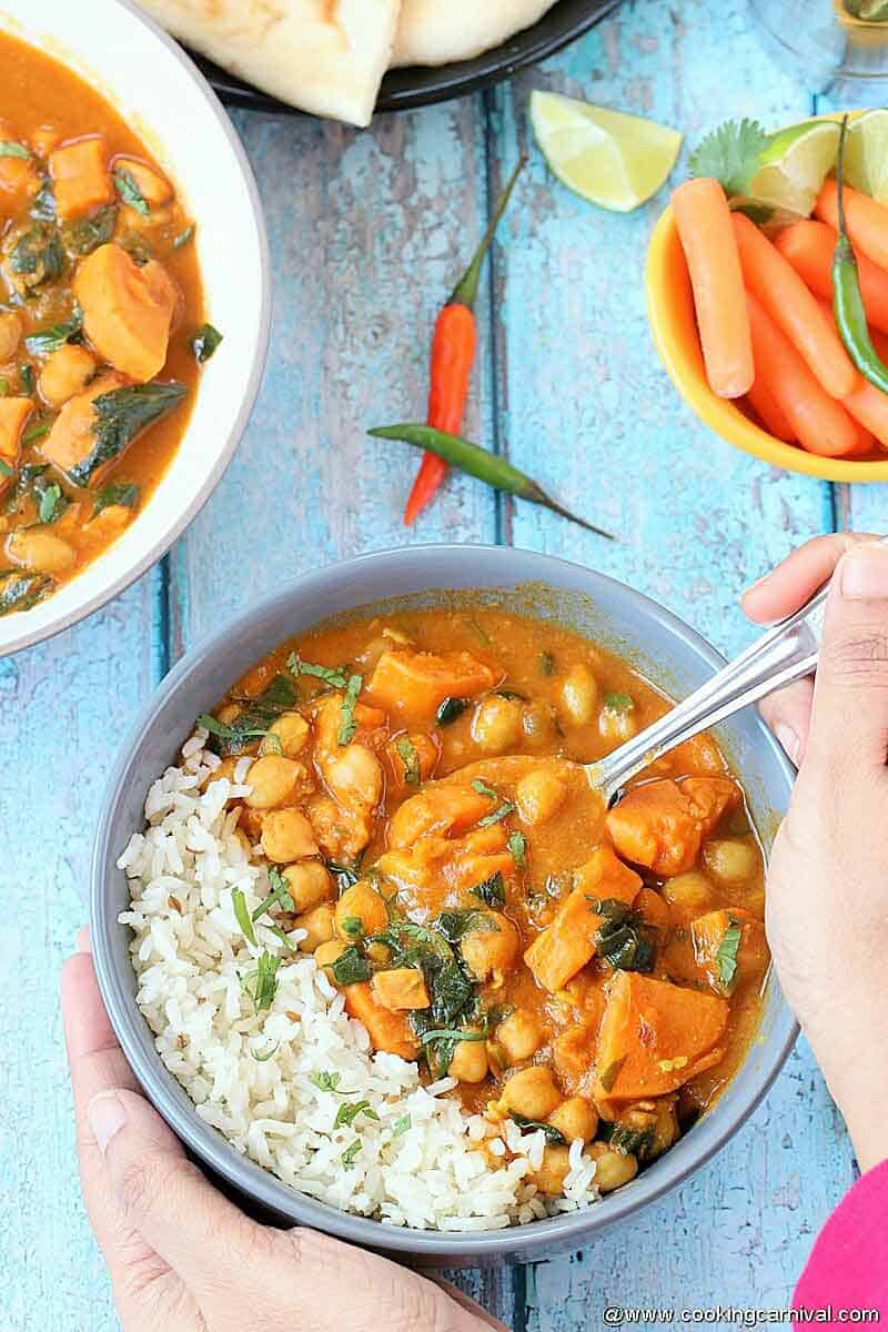 Spooning rice and Sweet potatoes curry which is made in pressure cooker