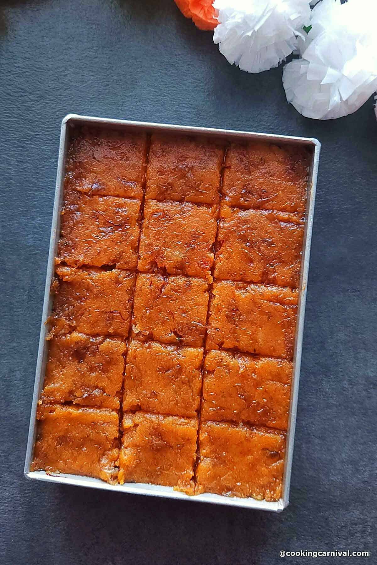 Milk powder burfi in a tray.