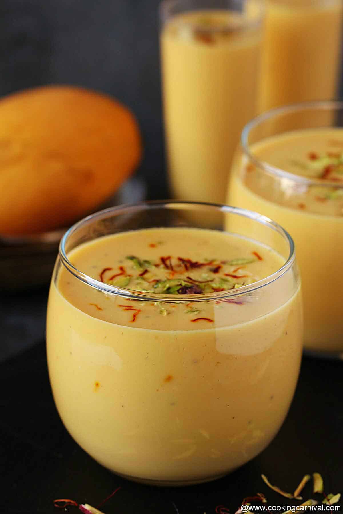 Mango lassi served in four glasses