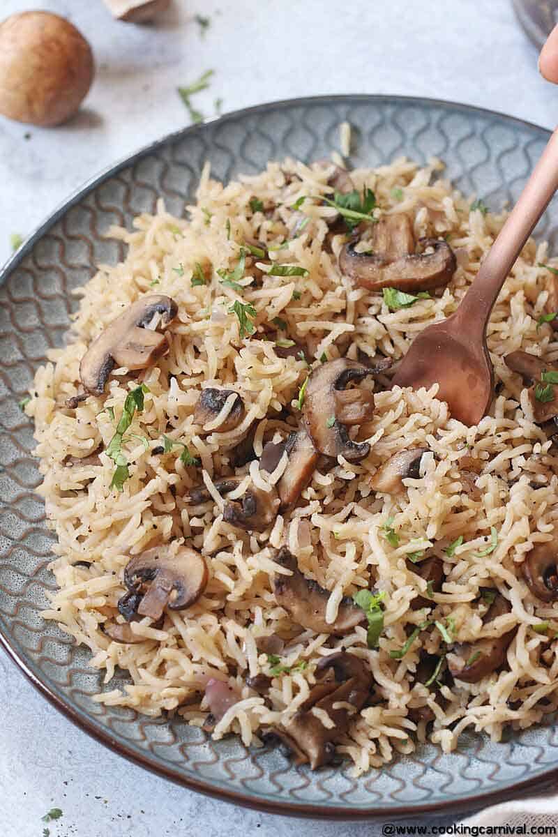 Bite shot of Instant pot mushroom pilaf with brown fork.