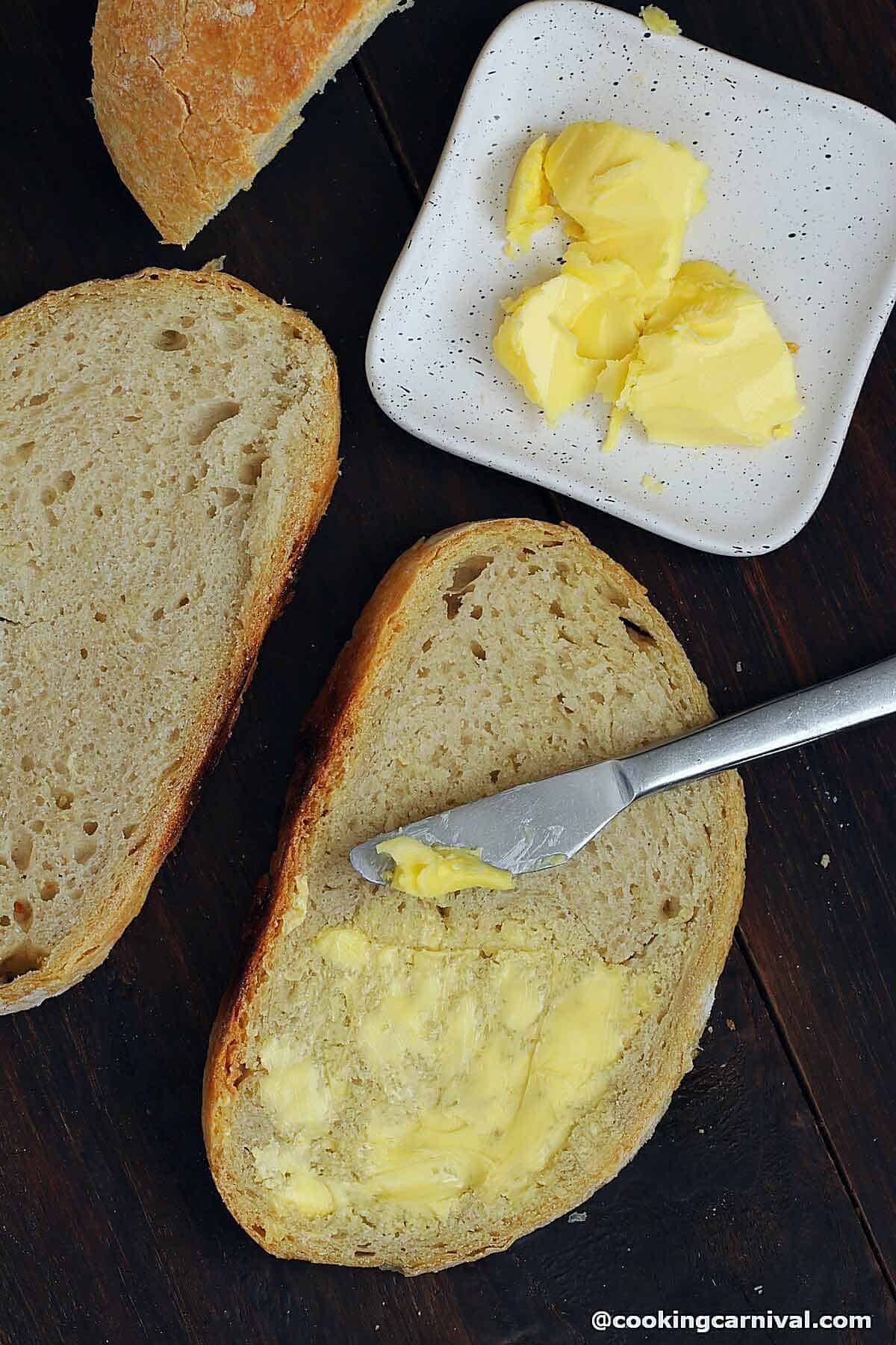 slices of no-knead bread, butter on top 