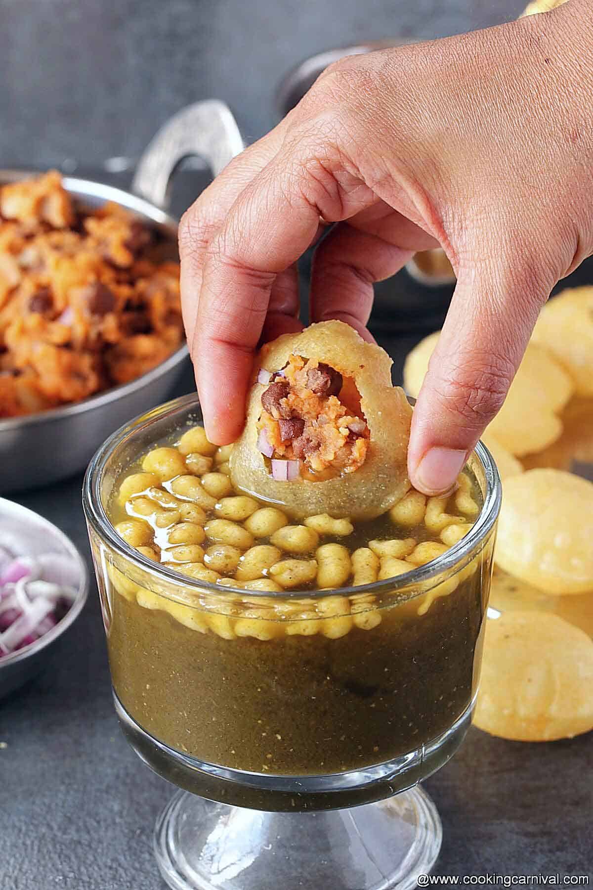 Dunking filled puri in mint spiced water