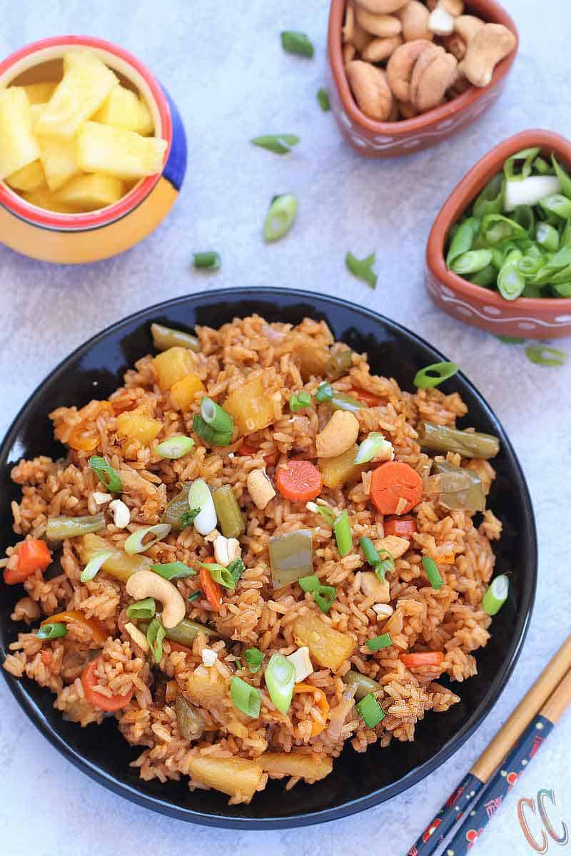 Classic and Exotic with tropical flavors - Thai Pineapple Fried Rice Recipe - Lovely blend of sweet- savory flavors and its Truly Heavenly. This Vegan Pineapple Fried rice preparation is a little bit spicy, tangy and sweet. Make it as the main course or as a side dish to any meal over the weekend. Thai Pineapple Fried rice is always a favorite.