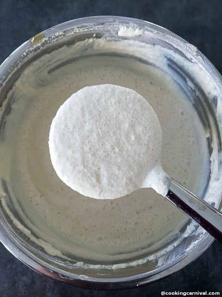 Fermented idli batter in a steel pot