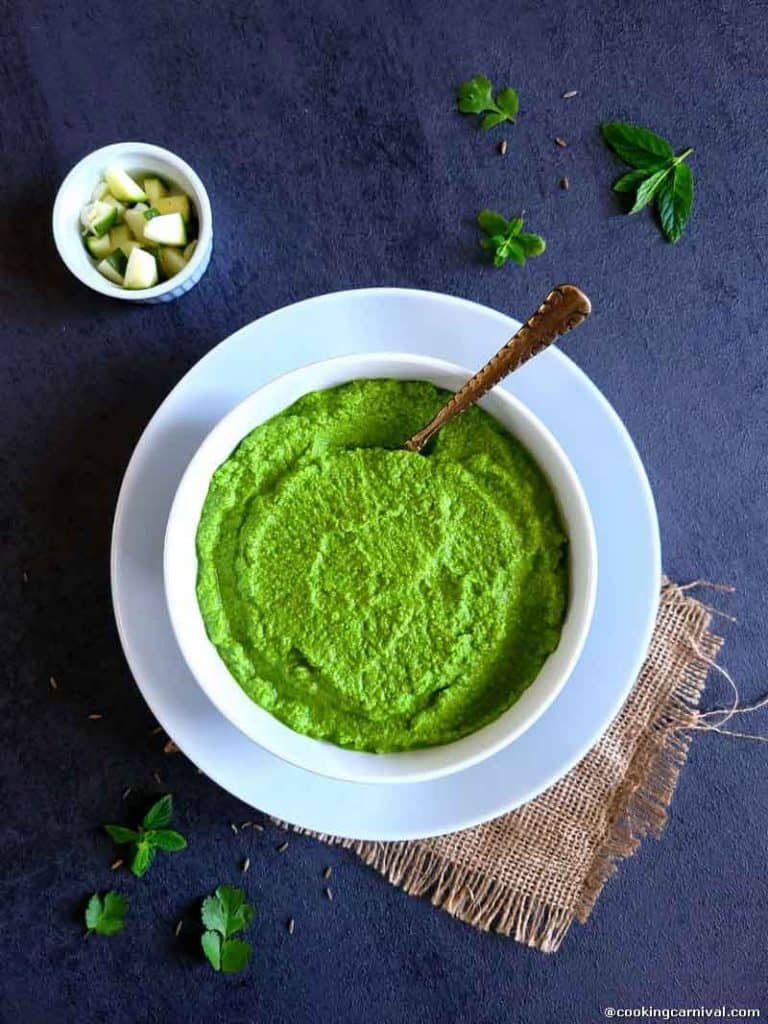 green mango chutney in a white bowl