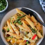 Spicy Chipotle Pasta made in instant pot and served in white bowl, fork, cilantro, adobo sauce on the side