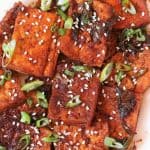 Spicy Braised Tofu / Dubu Jorim - A traditional Korean dish made with pan fried tofu, braised in a savory-spicy sauce with green onions and garlic. It's juicy, a little spicy and delicious. It is the best Korean Side Dish served with Rice, Noodles or with Coconut Quinoa.