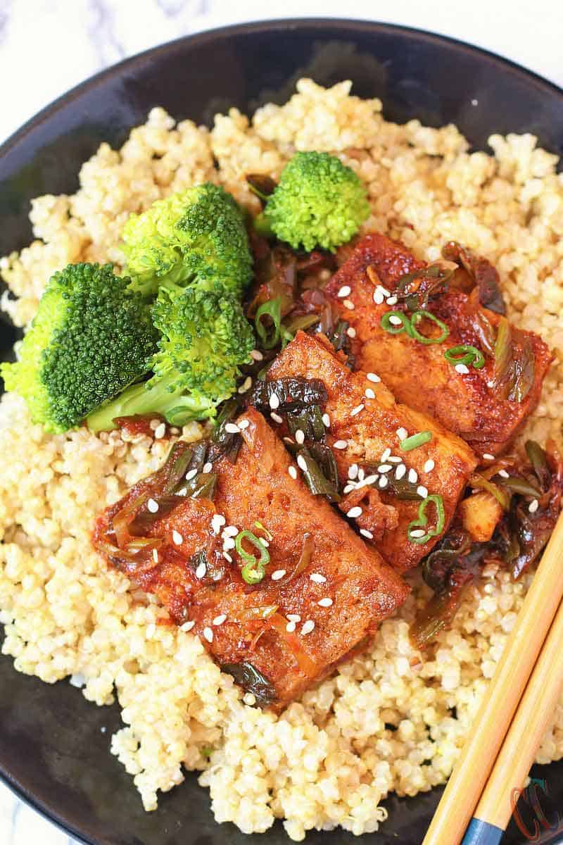 Spicy Braised Tofu / Dubu Jorim - A traditional Korean dish made with pan fried tofu, braised in a savory-spicy sauce with green onions and garlic. It's juicy, a little spicy and delicious. It is the best Korean Side Dish served with Rice, Noodles or with Coconut Quinoa.