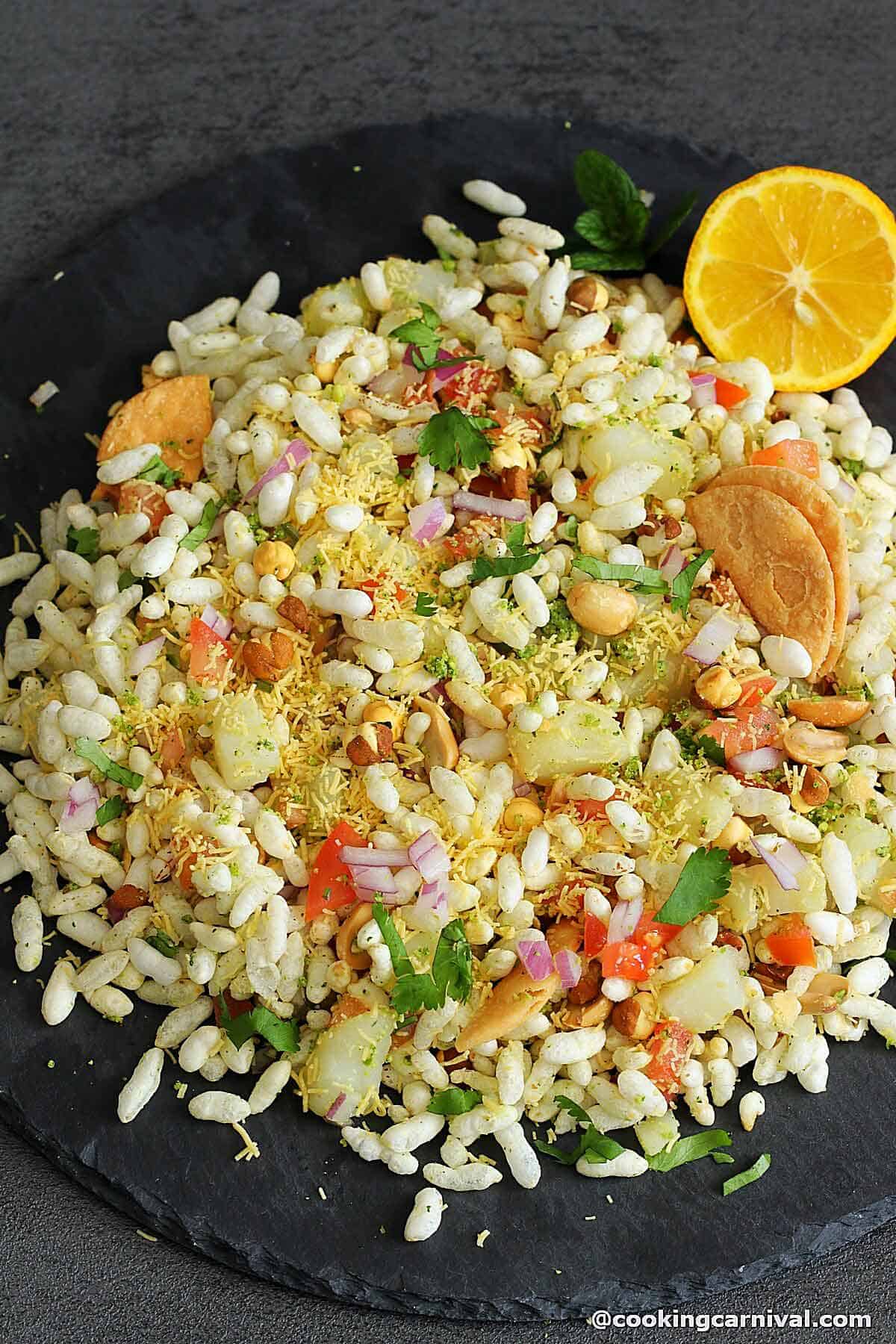 sukhi bhel served in a black plate.