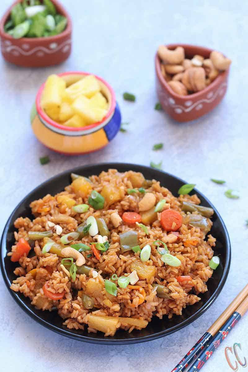 Classic and Exotic with tropical flavors - Thai Pineapple Fried Rice Recipe - Lovely blend of sweet- savory flavors and its Truly Heavenly. This Vegan Pineapple Fried rice preparation is a little bit spicy, tangy and sweet. Make it as the main course or as a side dish to any meal over the weekend. Thai Pineapple Fried rice is always a favorite.