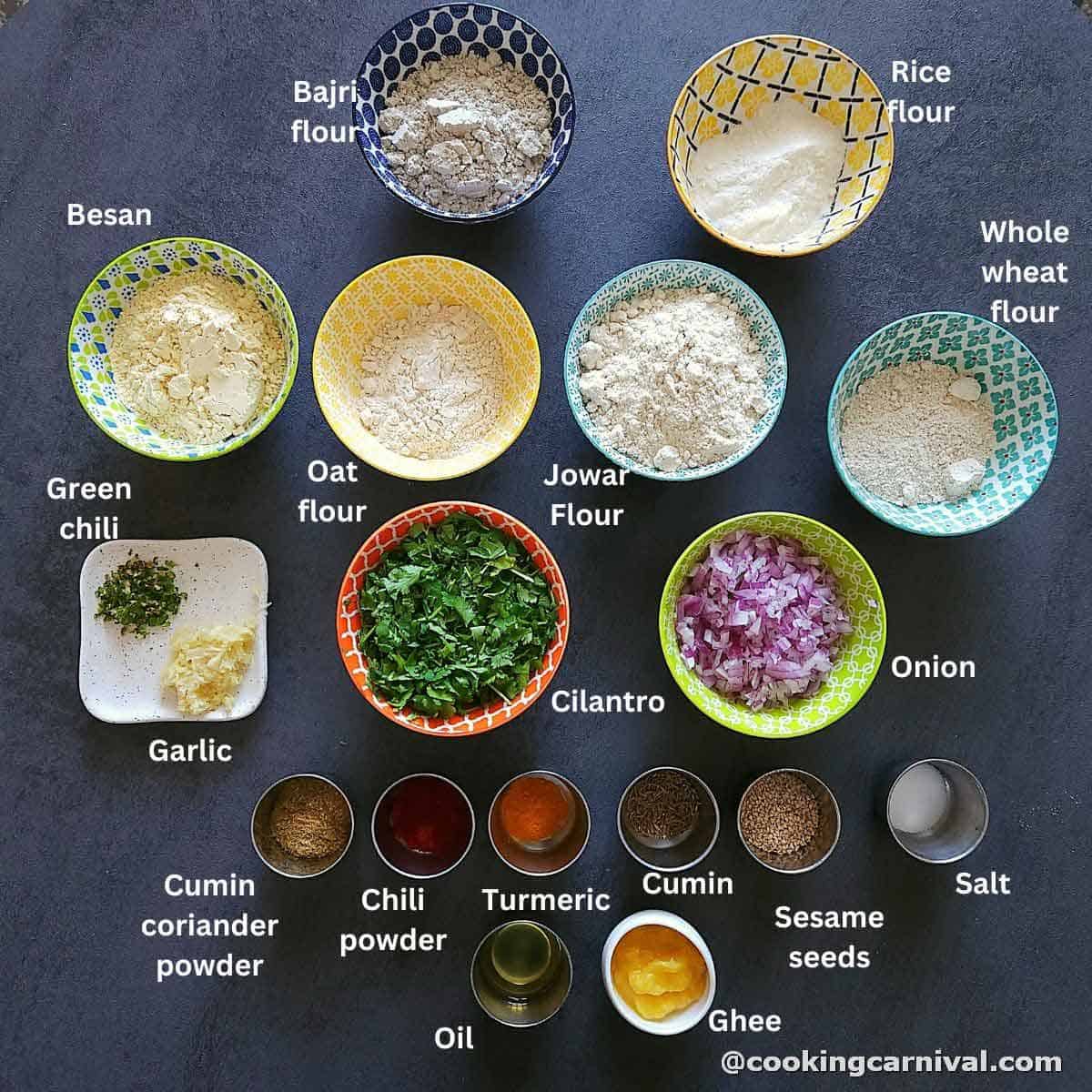 premeasured ingredients of thalipith on a gray board.