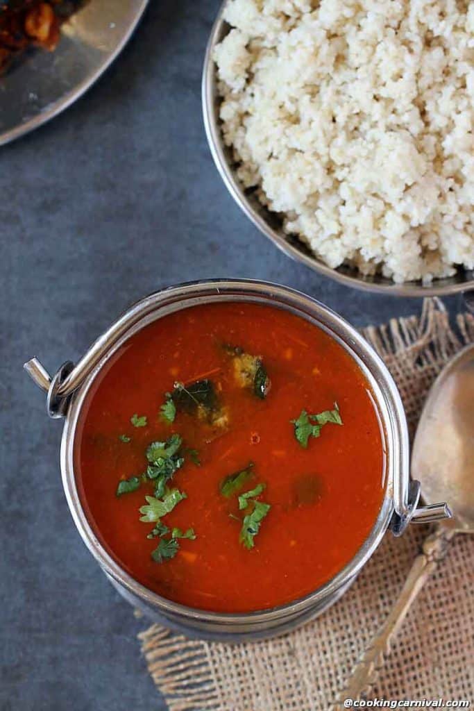 Tomato Rasam in a steel bucket