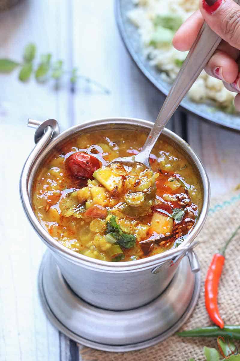 Mango Dal - Andhra Style Vegan Mango Dal recipe in the instant pot/pressure cooker. Toor Dal (Split Pigeon pea) cooked with Grated Raw mango and tempered with red dried chilies, ginger, garlic, green chilies, onion, curry leaves, cumin seeds and with basic spices.