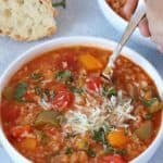 spooning vegetarian instant pot stuffed pepper soup from white bowl