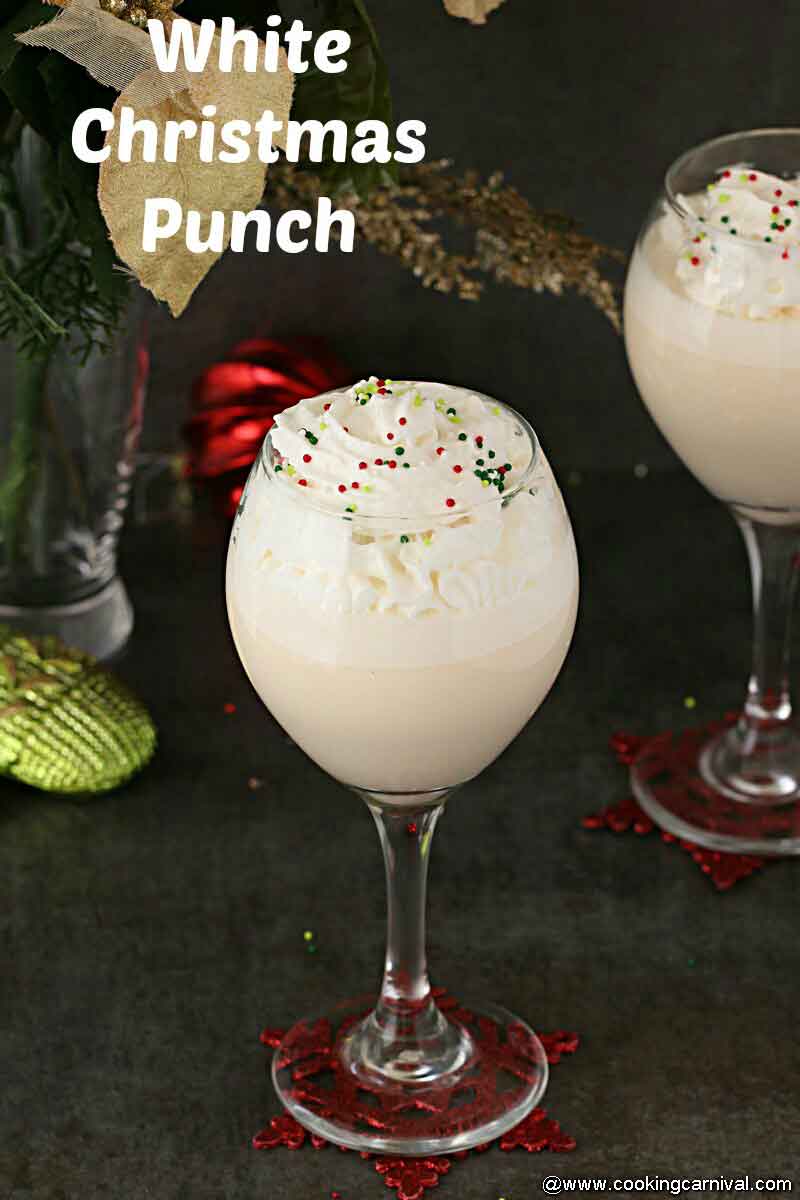 Christmas punch in a tall glass on a black backdrop