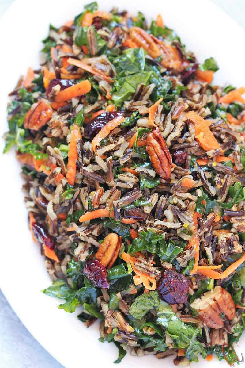 Wild Rice Salad - Scrumptious, Bursting with citrus flavors, Loaded with Vitamin C rich Kale and Vitamin A rich Carrots, lots of Pecans and cranberries for extra crunch and taste, Vegan Salad recipe that can be enjoyed at any time of the year.