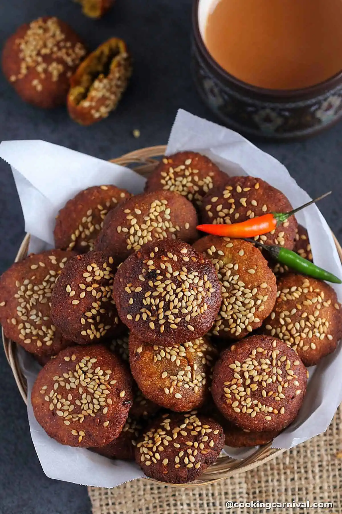 Bajri na vada in a bowl, masala chai on a side. 