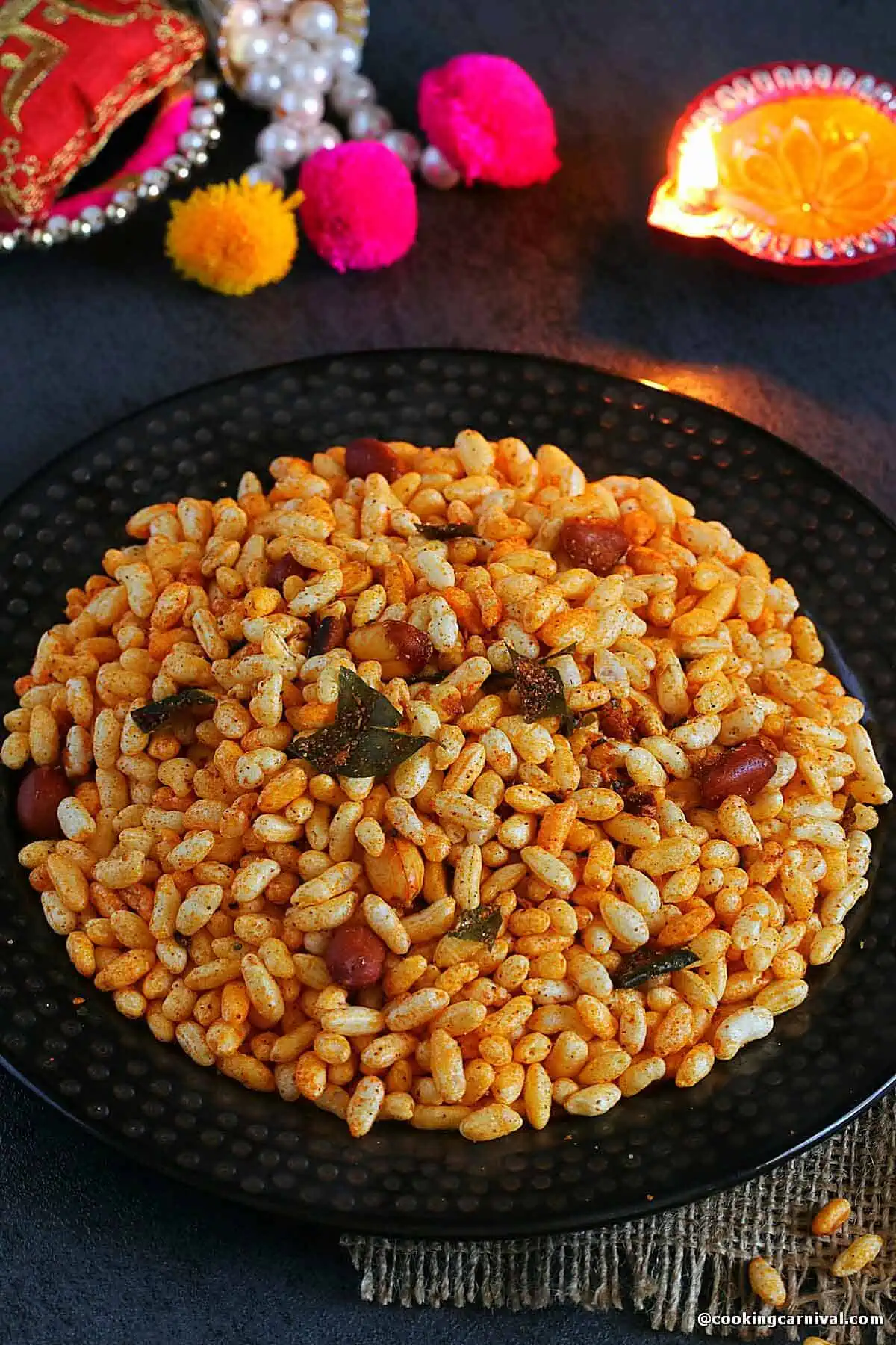 Traditional kolhapuri Bhadang in a plate, a diya on the side.