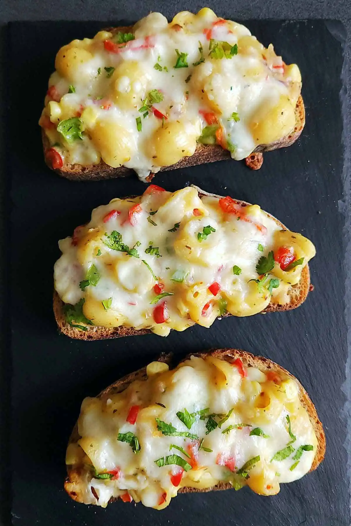 Three Cheese Corn Pasta Open Sandwich on a plate.