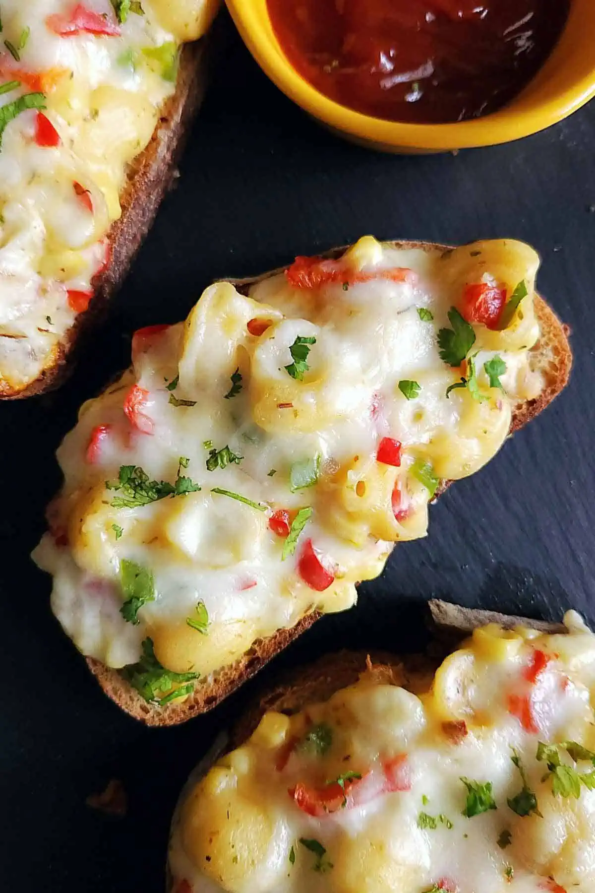 Cheese Corn Pasta Open Sandwich on a black board