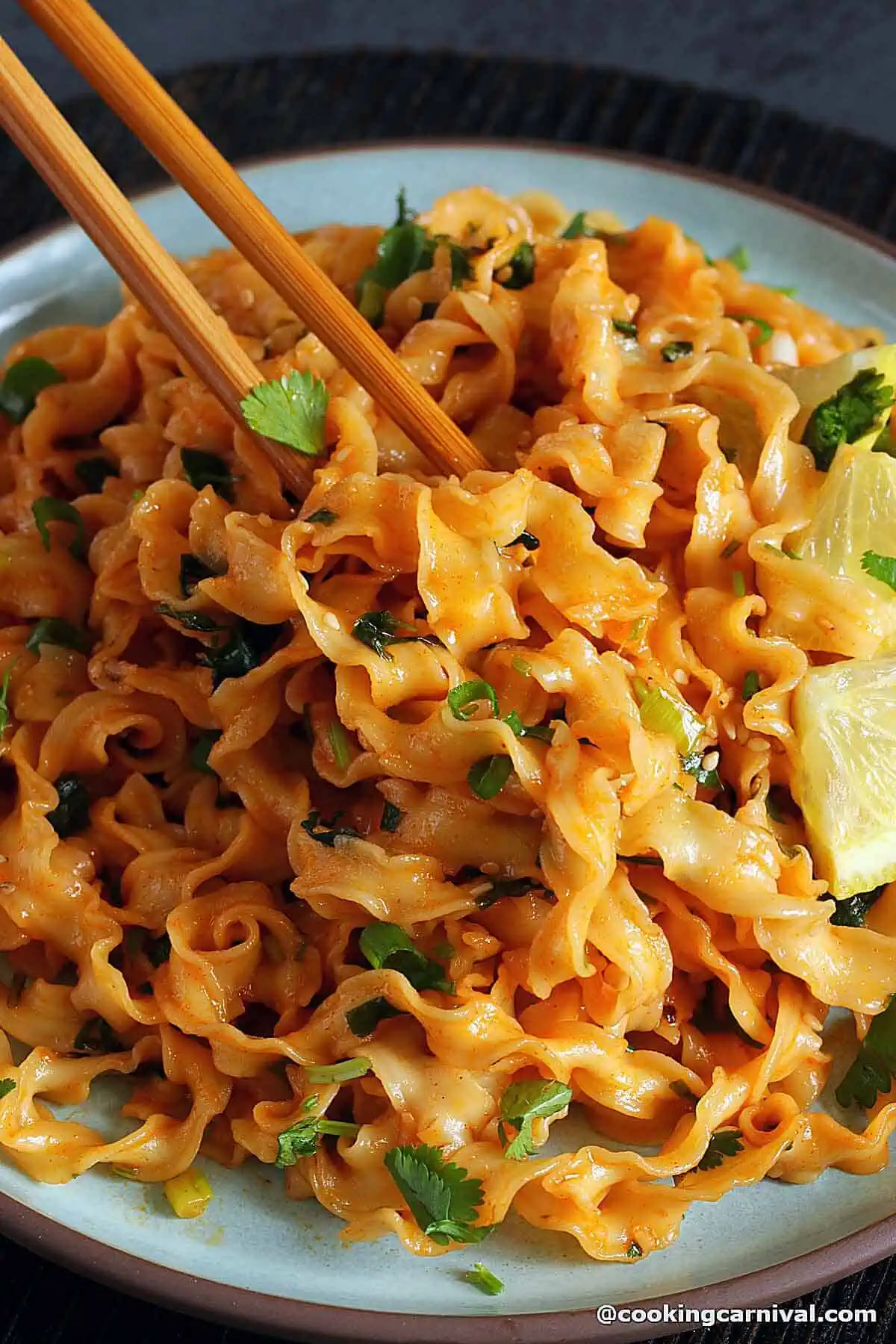 Taking gochujang noodles with chopsticks. 