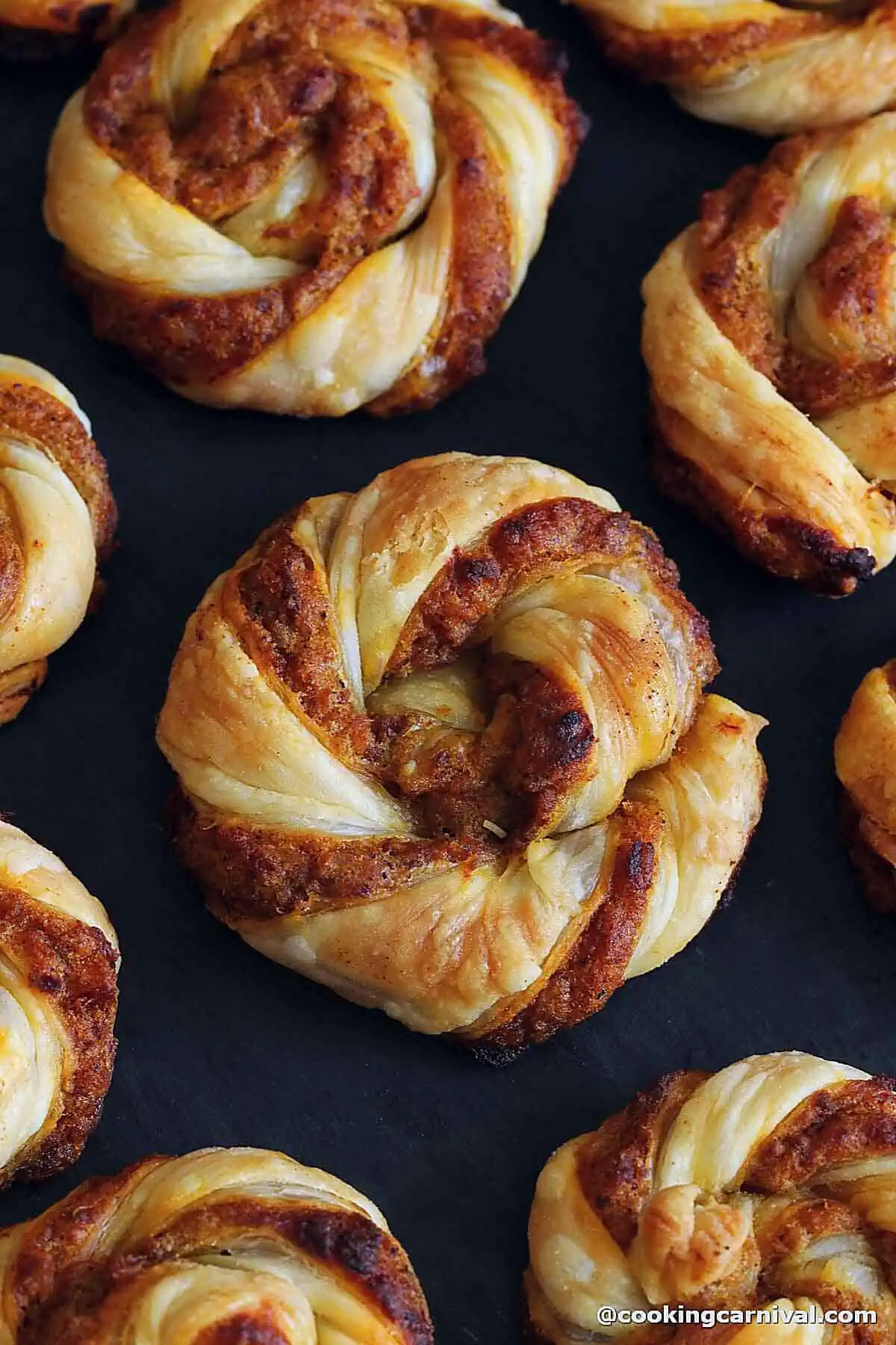 close up looks of appetizer - dabeli puff pastry swirls.