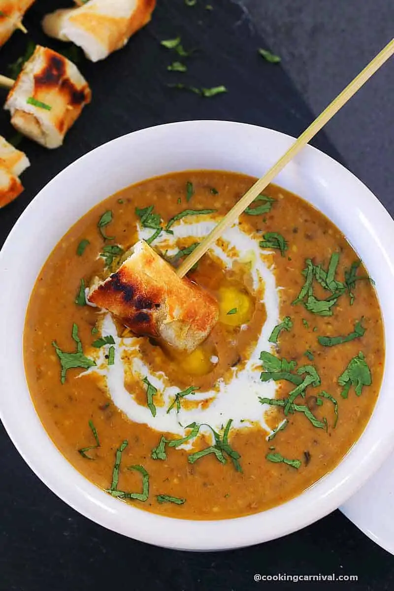 dipping garlic naan in Dal makhani fondue